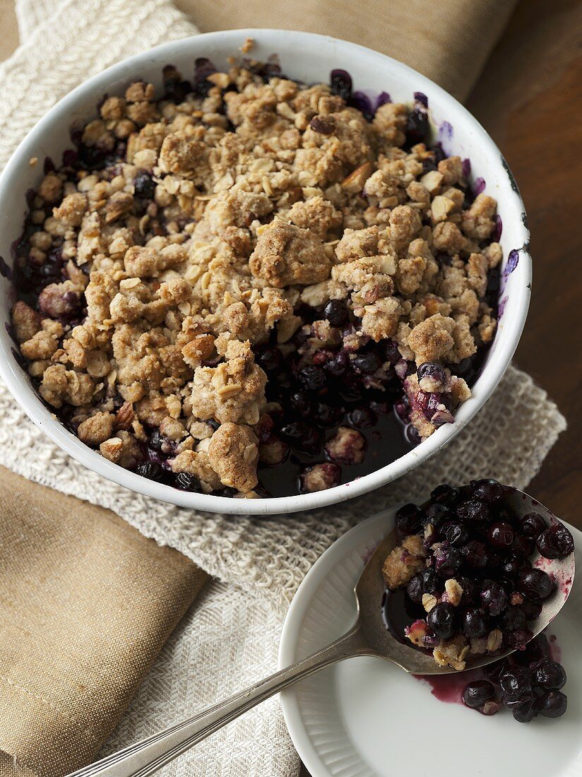 Blueberry Cobbler in Baking Dish; Scoop Removed; Spoon