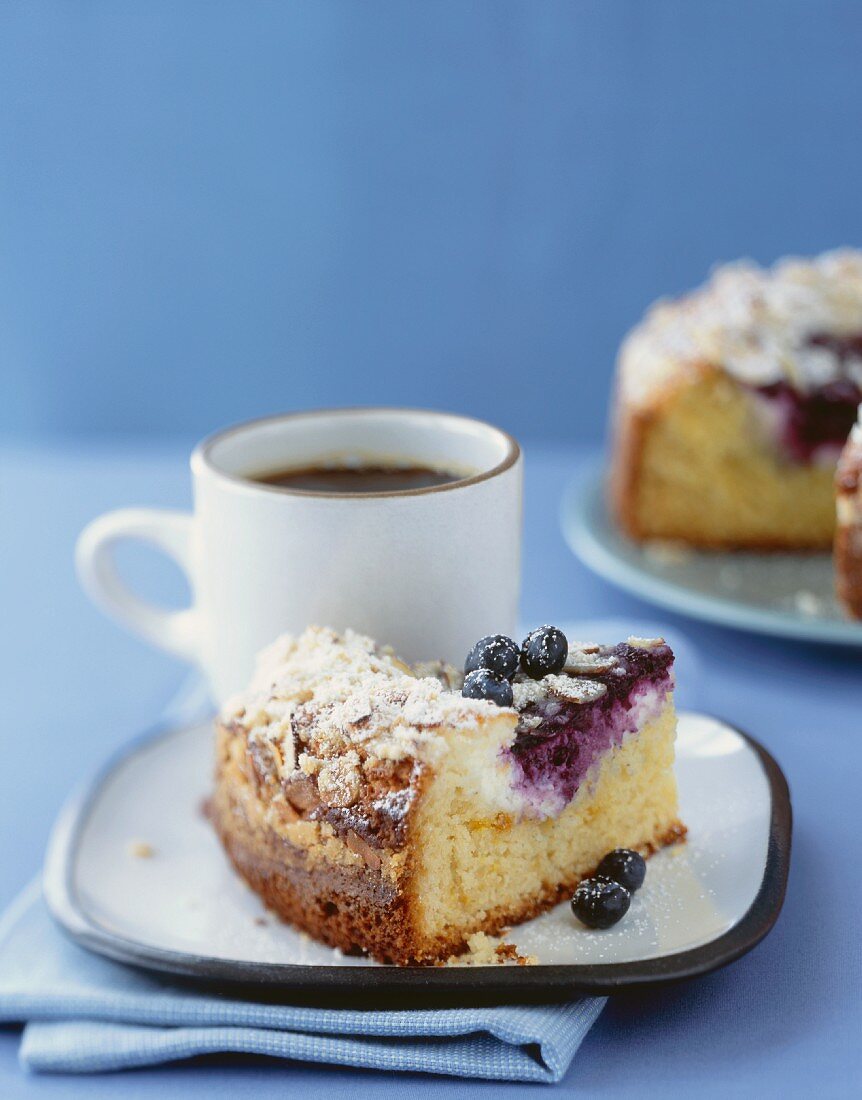 A Piece of Blueberry Coffee Cake with a Cup of Coffee