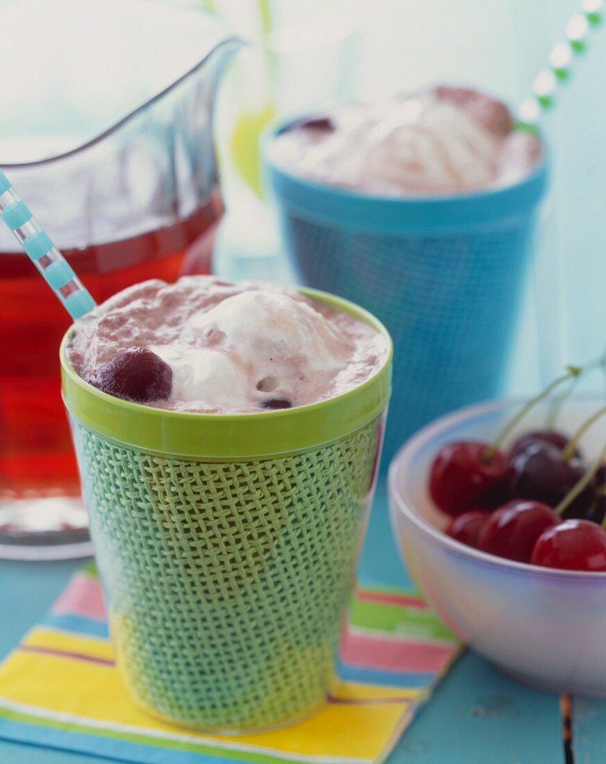 Cups of Cherry Ice Cream Sodas with Straws; Fresh Cherries