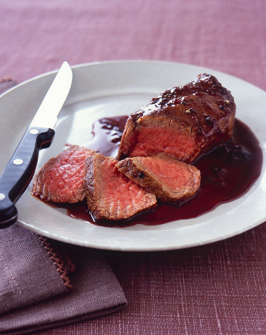 Partially Sliced Steak with Cherry Balsamic Sauce
