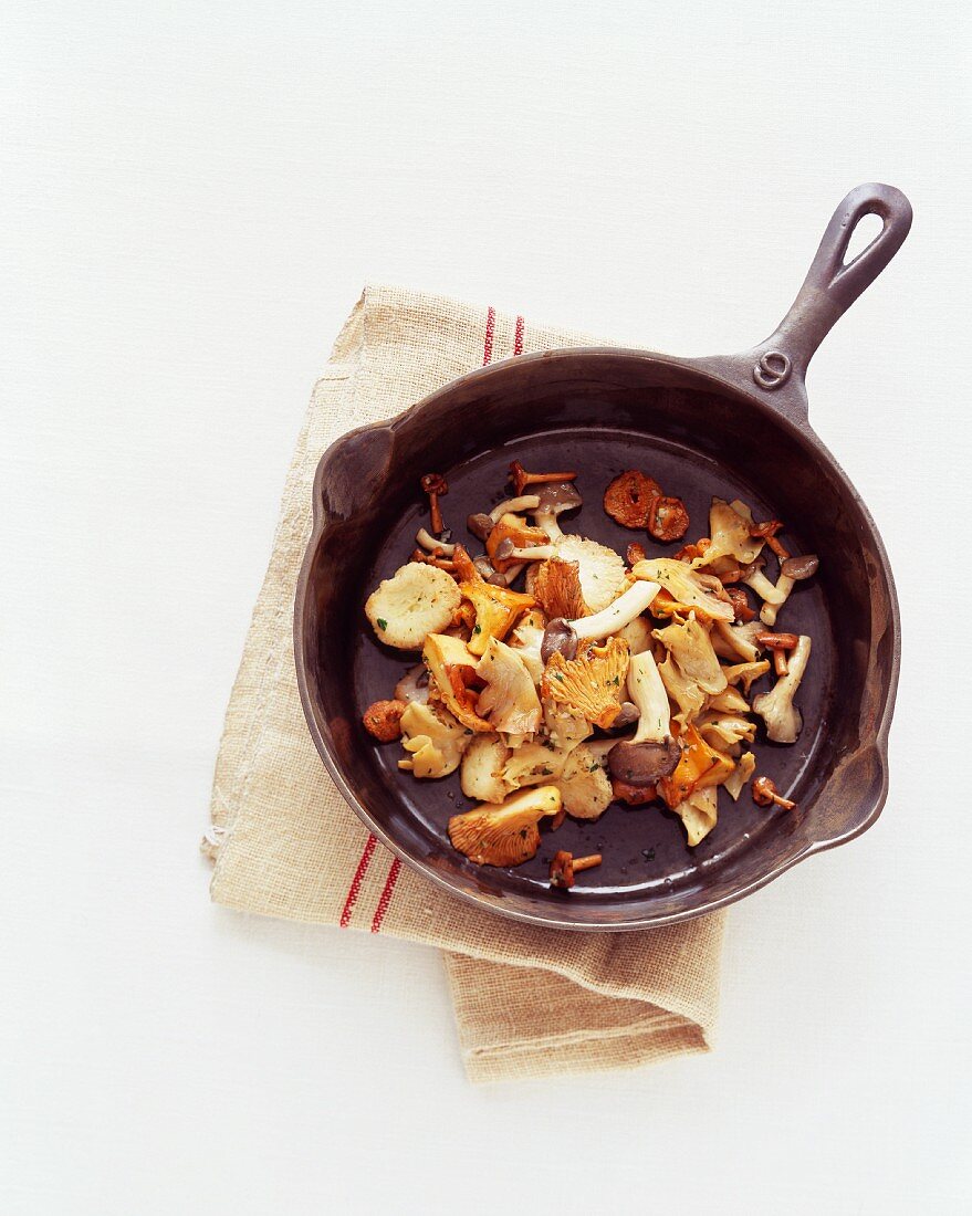 Various Mushrooms in a Cast Iron Skillet; From Above