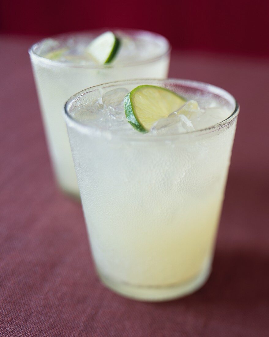 Two Glasses of Limeade with Ice and Lime Garnish