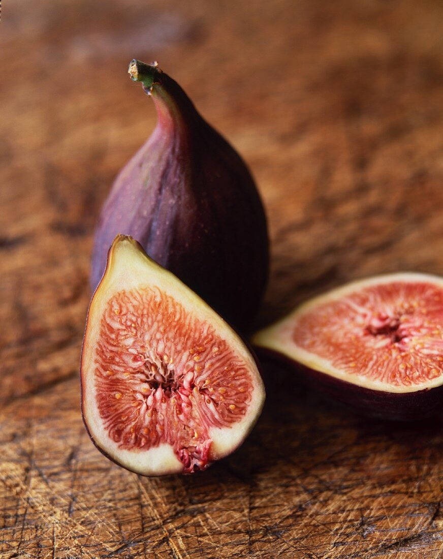 Halved and Whole Figs on a Cutting Board