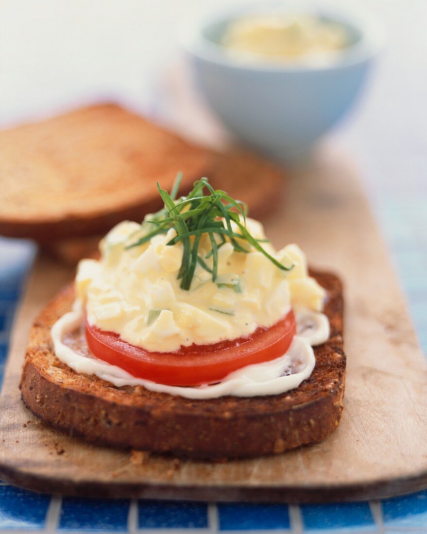 Open Face Egg Salad Sandwich with Tomato and Mayonnaise on Toasted Bread