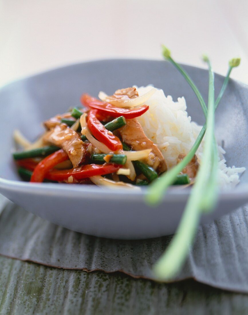 Chicken and Veggie Stir Fry Served with White Rice in a Bowl