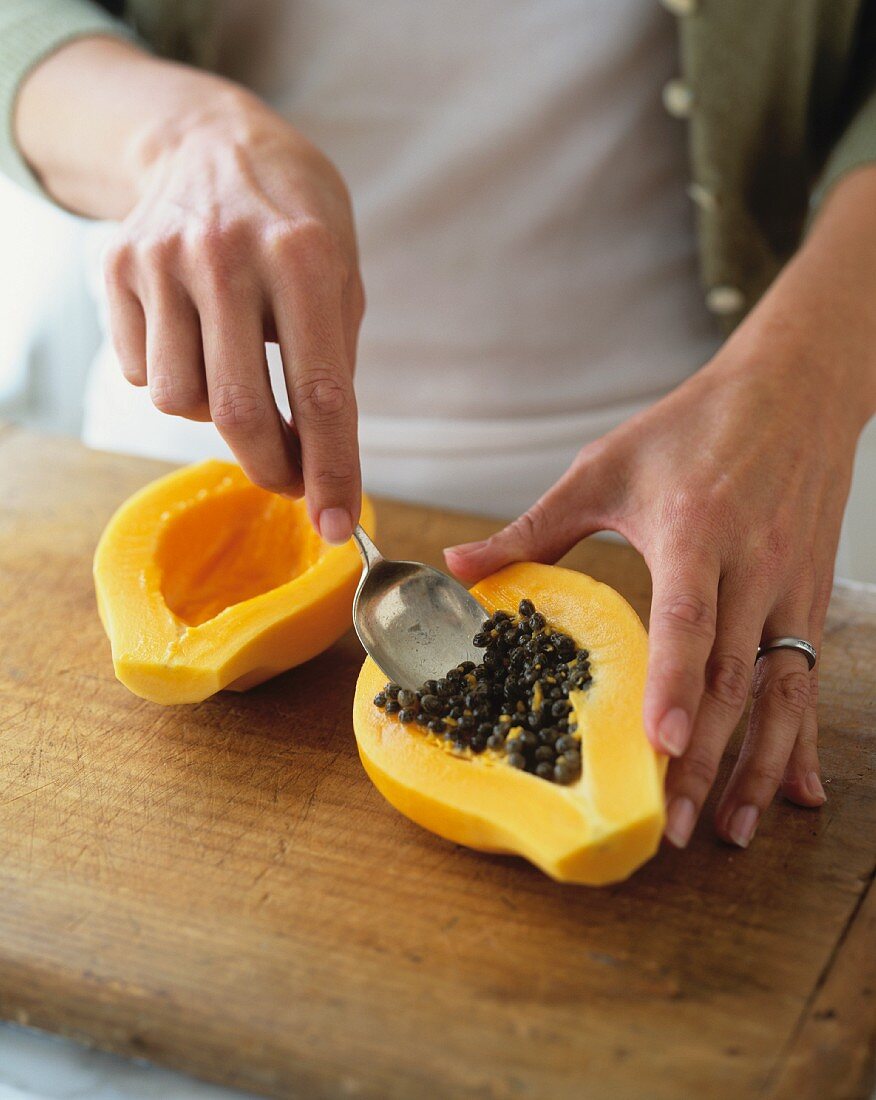 A papaya being hollowed out