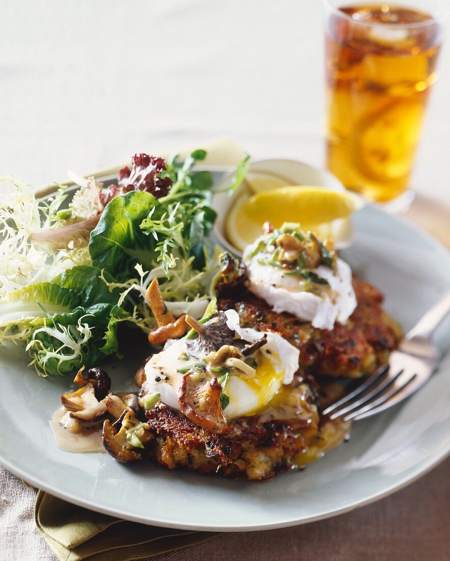 Mushroom cakes with poached eggs and Hollandaise sauce and a side salad