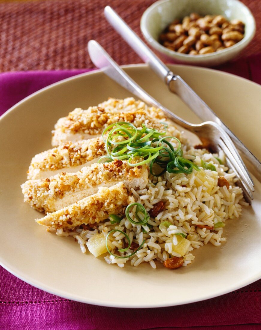 Breaded chicken breast with pineapple and pistachio rice