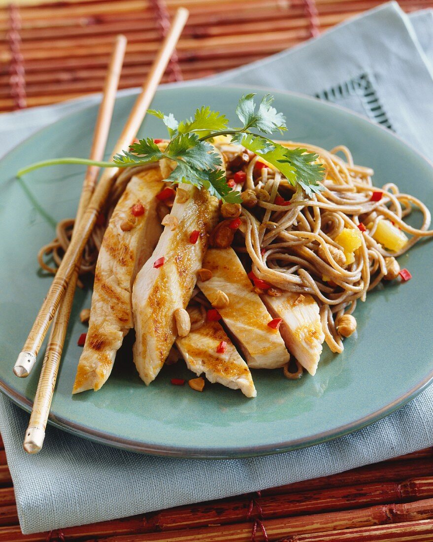 Grilled chicken strips with peanuts, pepper and noodles (Asia)