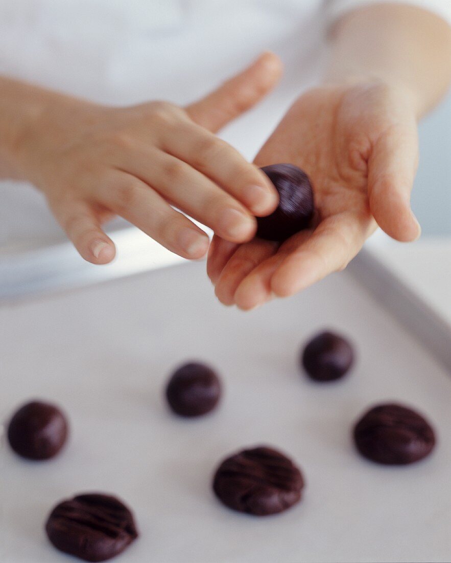 Hands Rolling Chocolate Cookies
