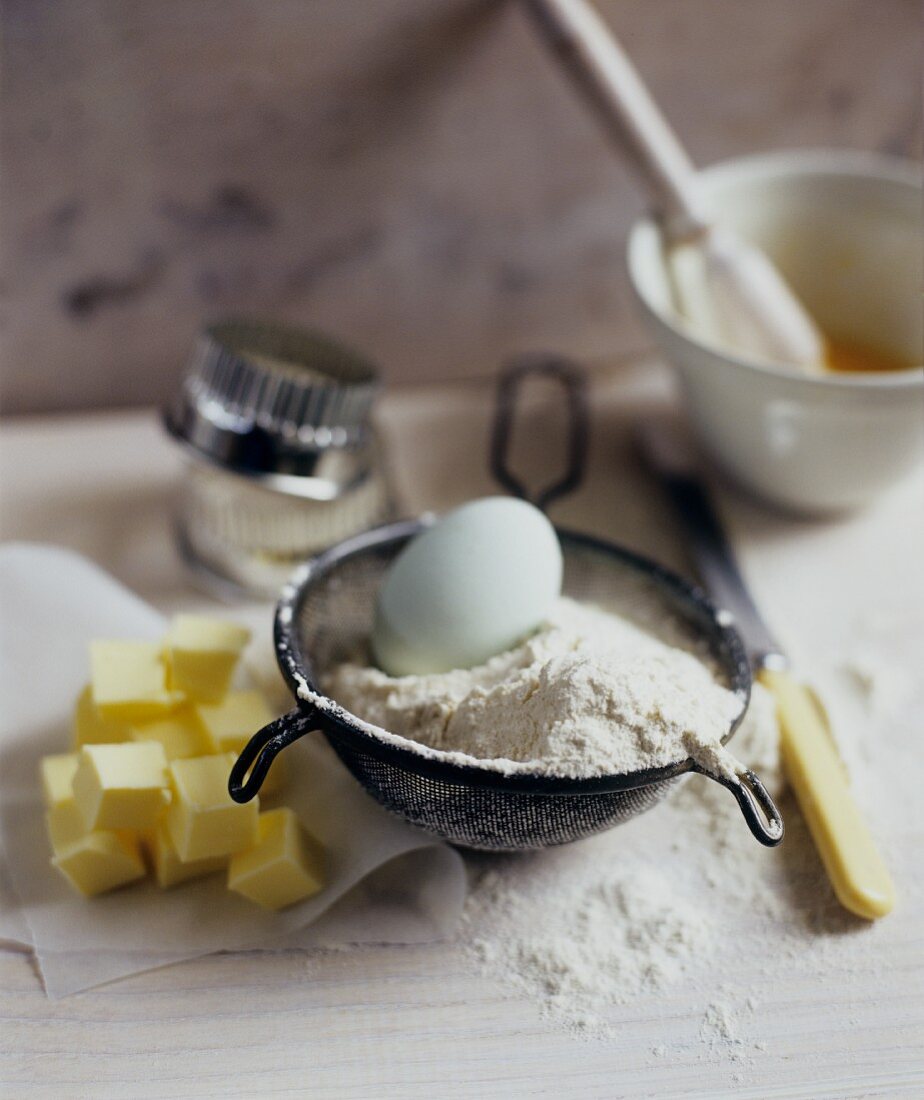 Baking Ingredients: Egg, Flour, Butter with Sifter