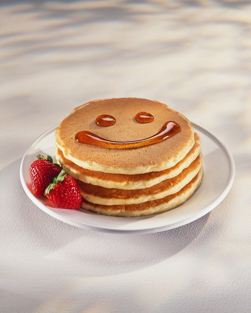 Pancakes with a Maple Syrup Smiley Face; Fresh Strawberries