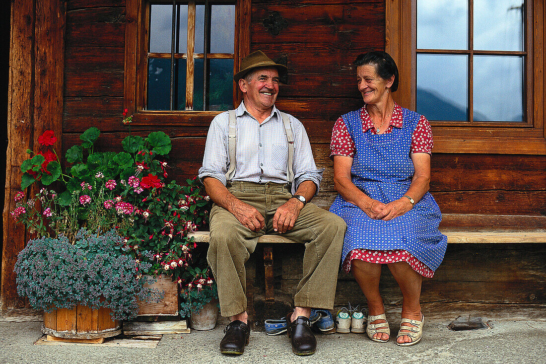 Local married couple before their farmhouse, Bavaria, Germany