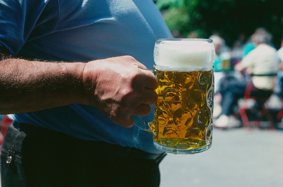 Man carrying one liter of beer, Bavaria, Germany
