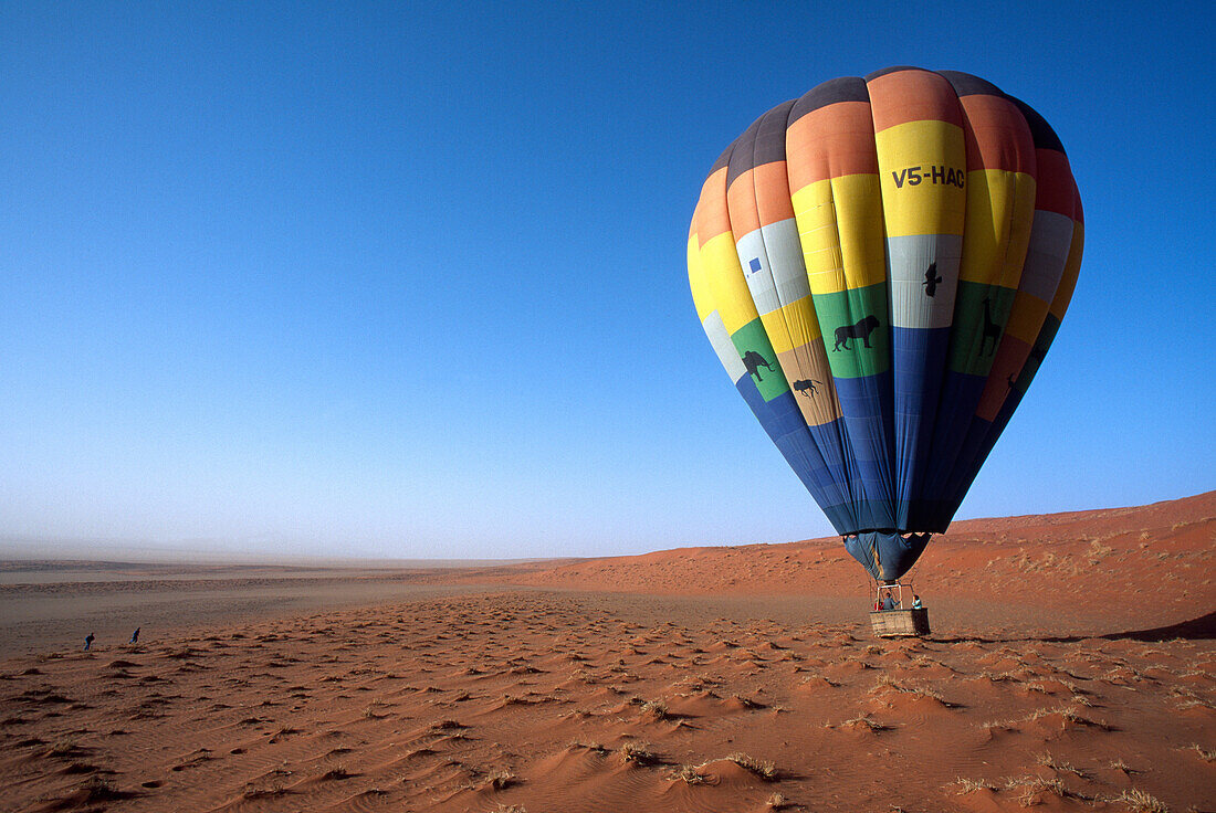 Menschen in einem Heissluftballon schweben dicht über dem Boden, Namibia, Afrika