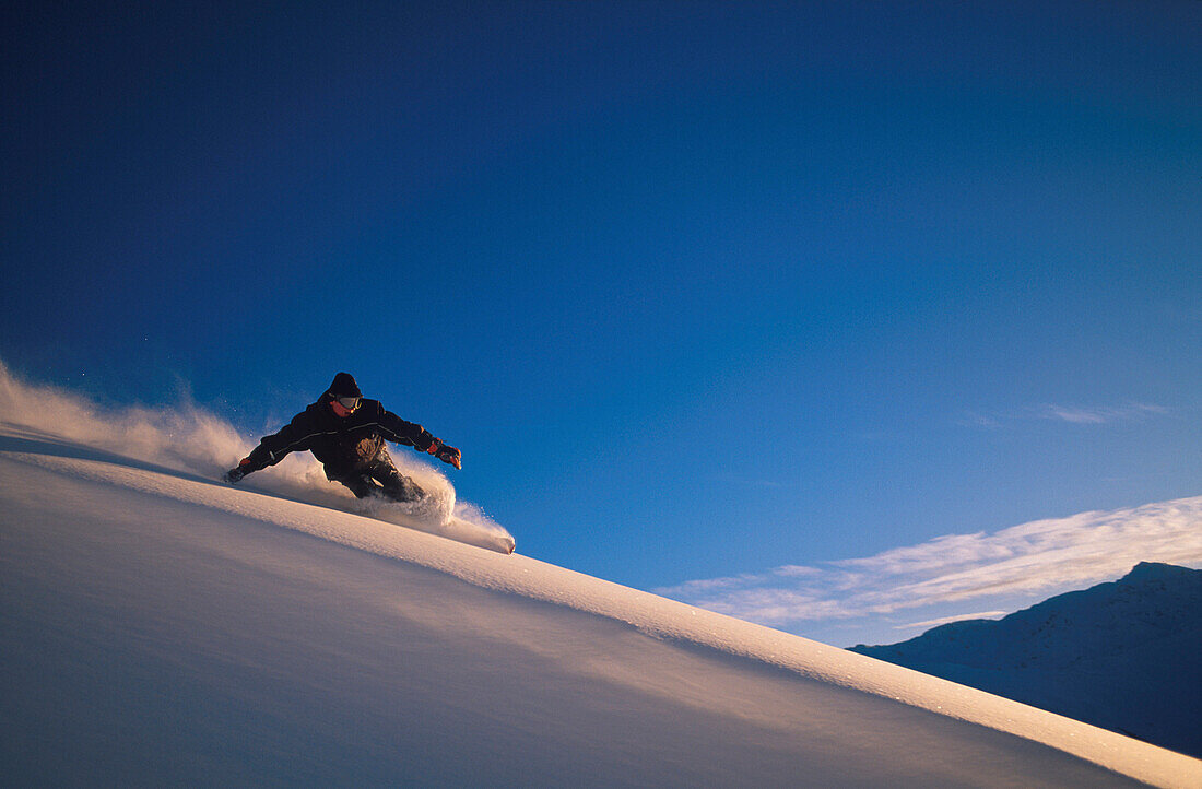 Young man, Snowboarding in powder snow