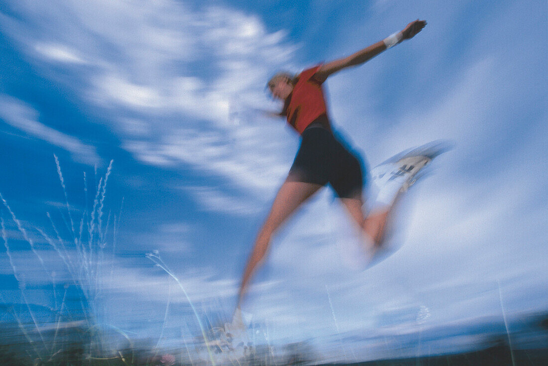 Young woman jogging, Blurred motion