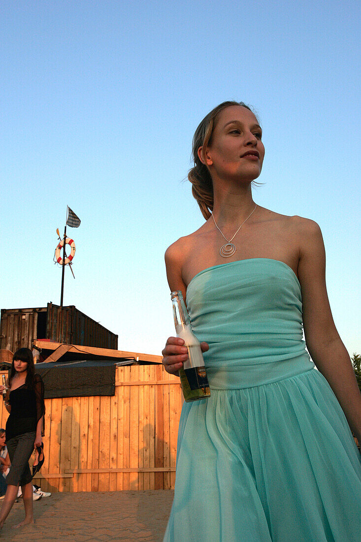 Young woman drinking beer, Berlin, Germany