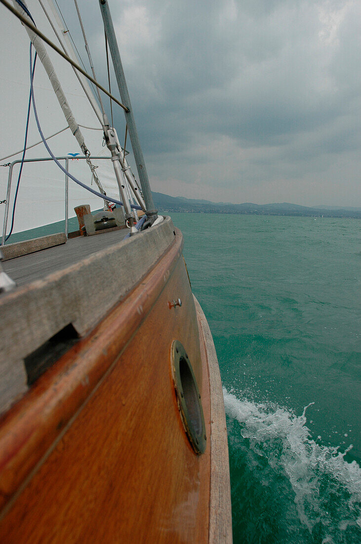 Water splashing at side of wooden yacht, Lake of Constance, Germany