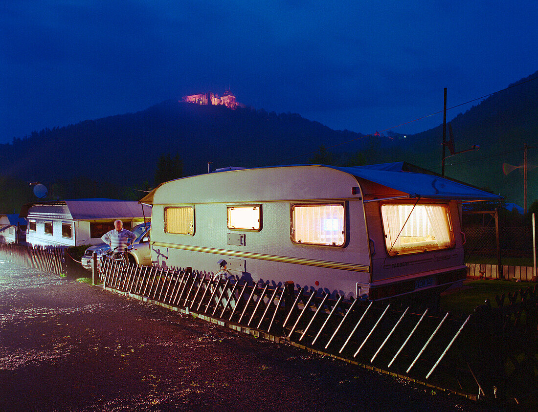 Trailer on campground at night, Nideggen Castle, Eifel, Germany