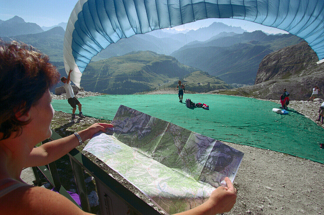 In preparation for paragliding, near Corvara, Dolomites, Alta Badia South Tyrol. Italy
