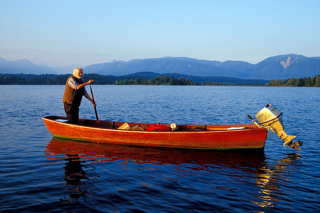 Fisherman in his boat, Staffelsee, Murnau, Upper Bavaria, Germany