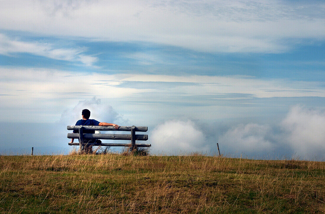 Man sitting on a bench, Belchen, Black Forest, Baden-Wuerttemberg, Germany