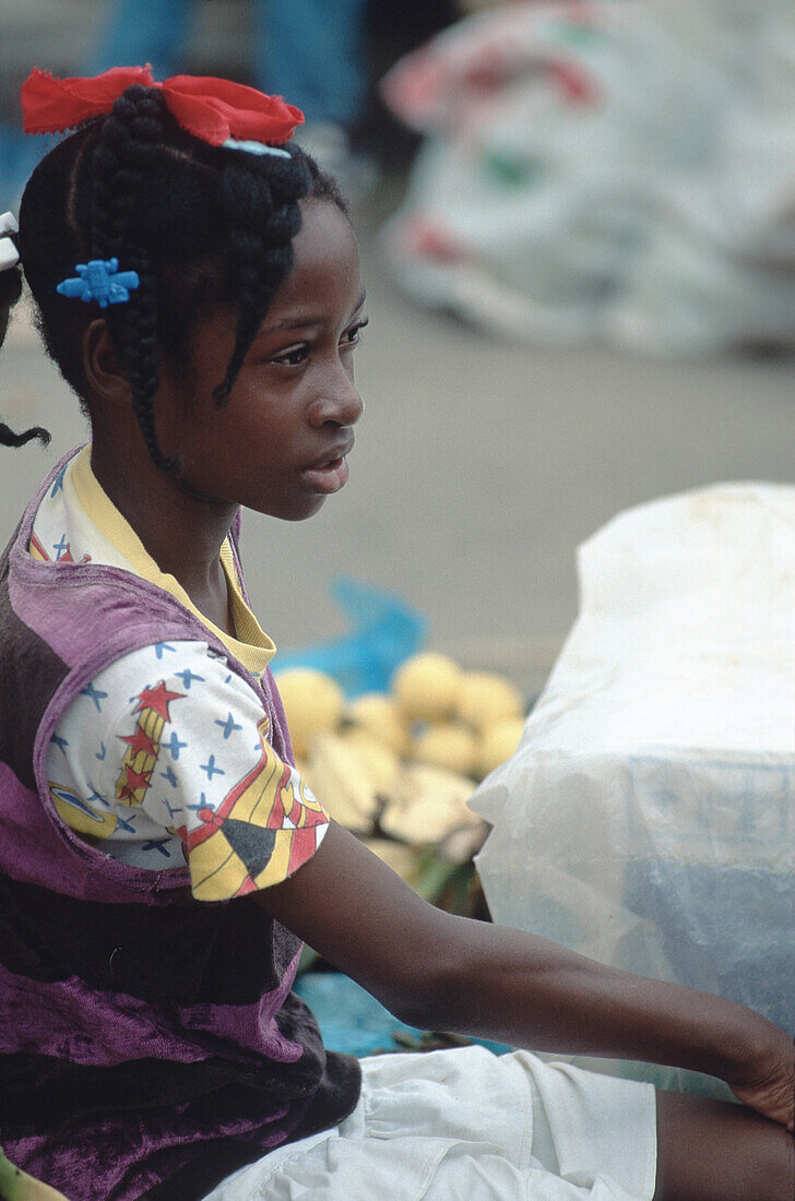 Youngster sitting on market in Castries, St. Lucia, Caribbean