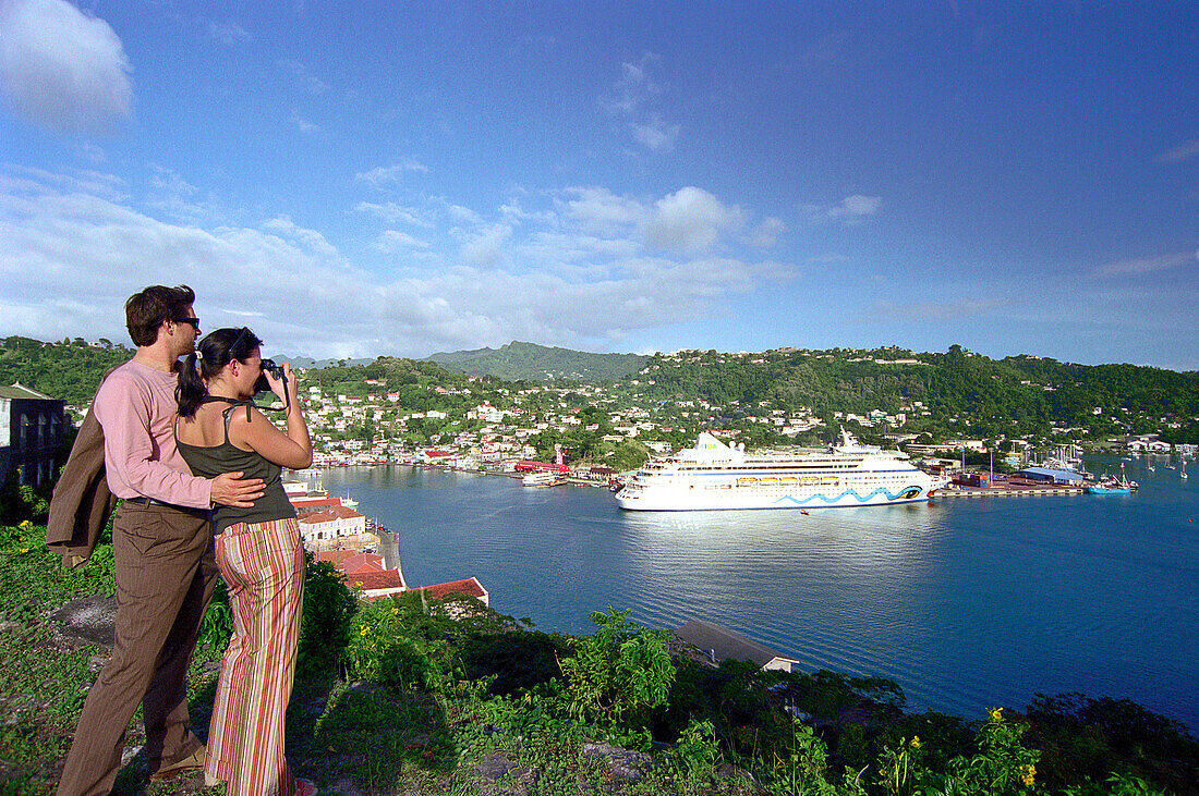 Couple photographing cruise ship AIDA at harbour, St. George´s, Grenada, Caribbean, America