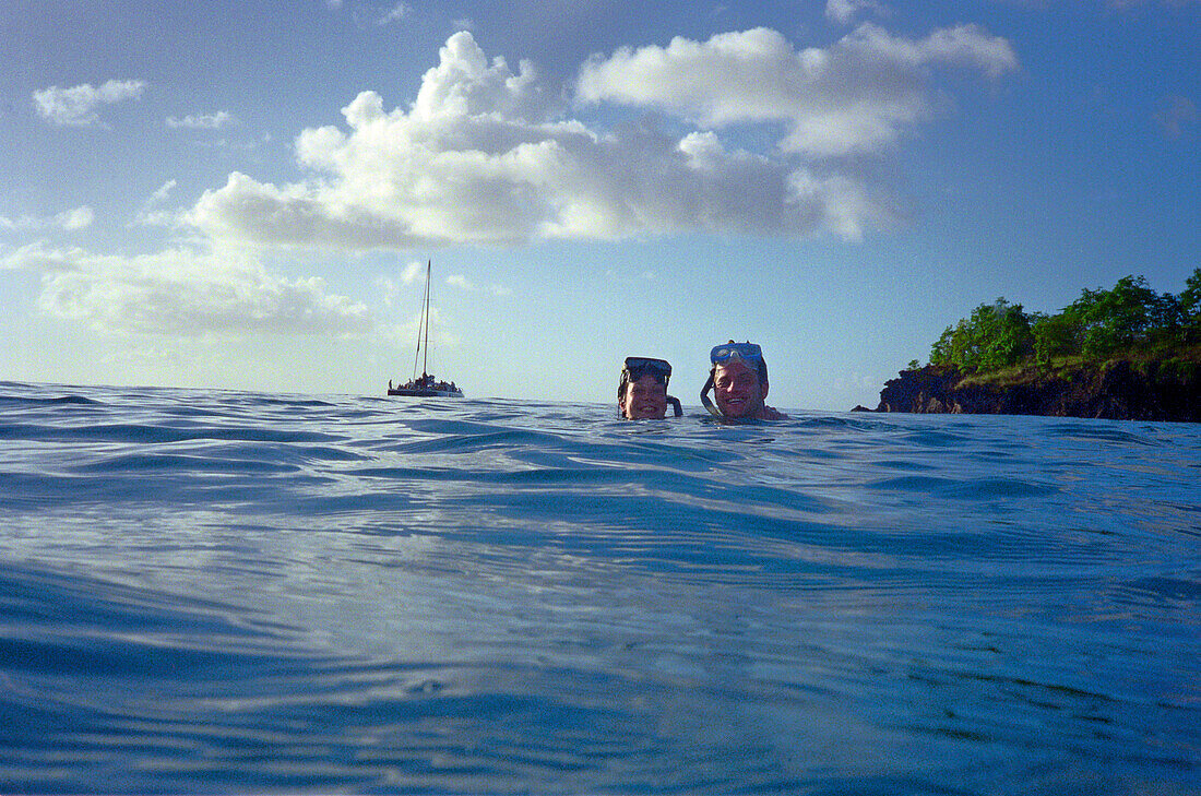 Young couple swimming in the ocean, St. Lucia, Caribbean, America