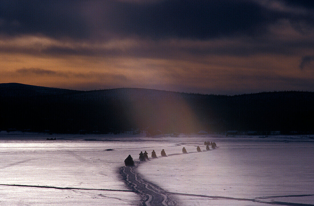 Snowmobiles in semi-dark, Lappland, Sweden