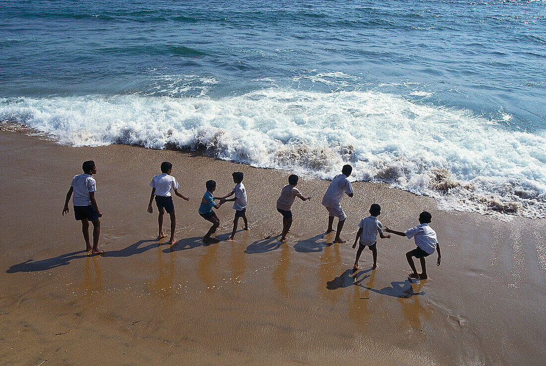 Kids playing on the beach, Ocean Drive, Colombo, Sri Lanka