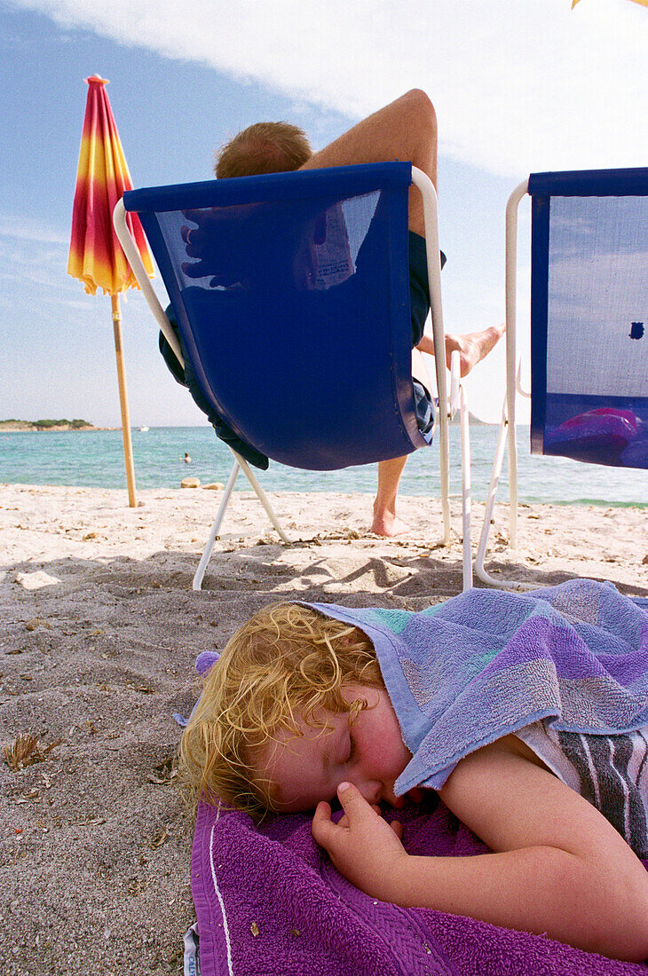 Sleeping Child on the beach, Sardinia, Italy