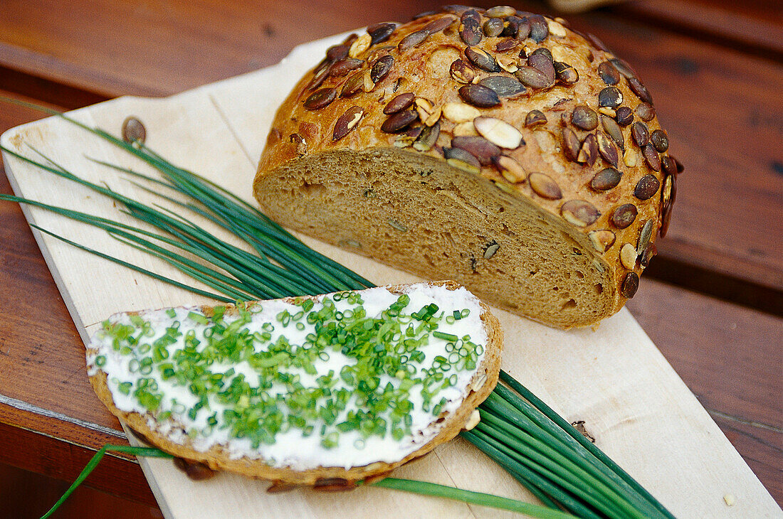 Sclive of bread with cream cheese and chive, Beer garden, Munich, Upper Bavaria, Bavaria, Germany