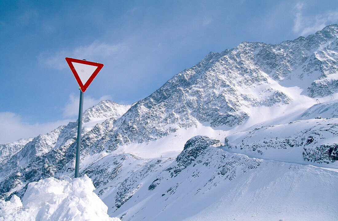 Traffic sign in front of snow covered mountains, Rettenbachtal, Oetztal, Tyrol