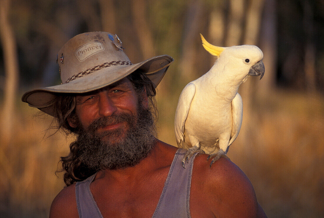 Bushman with cockatoo, Austrailian Bush, Australia