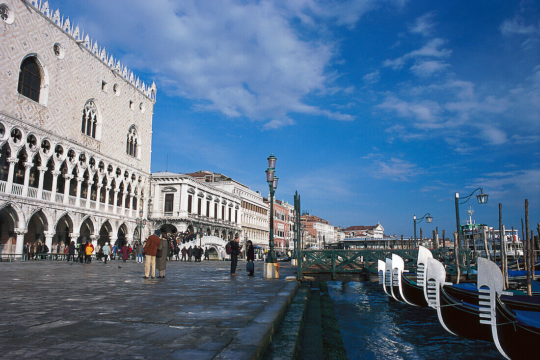Gondolas moored on the molo, the Doge's palace, Venice, Veneto, Italy