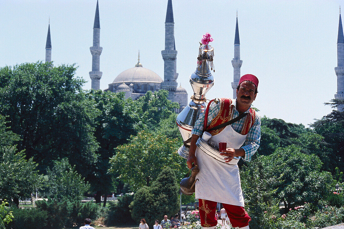 Tea vendor in traditional clothes, Blue Mosque, Istanbul, Turkey