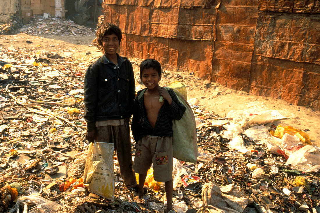 Two children standing in the garbage, New Delhi, India, Asia
