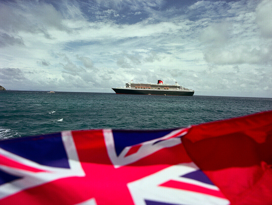 Queen Mary 2 & Union Jack, before coast of St. Maarten