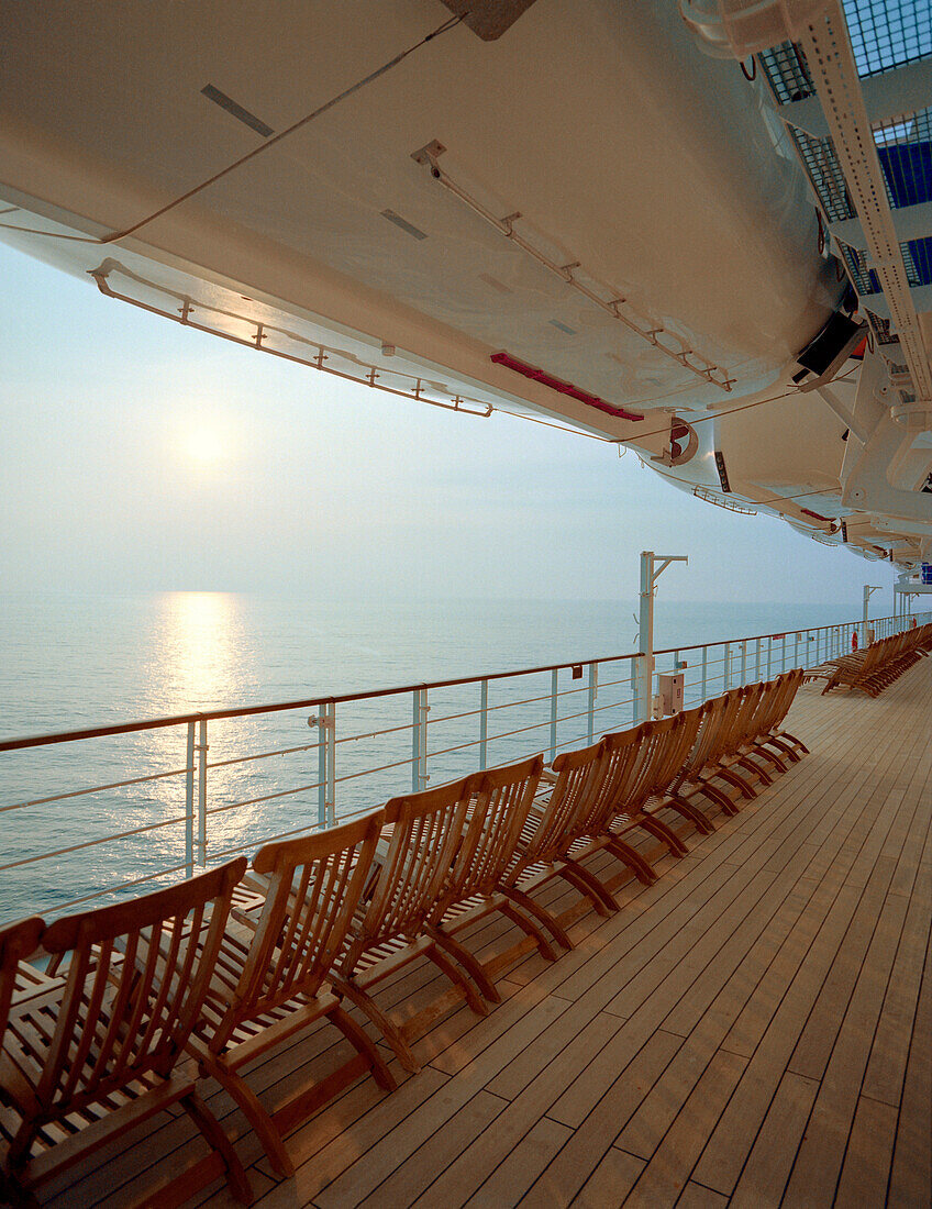 Reling und Liegestühle auf einem menschenleeren Deck, Kreuzfahrtschiff Queen Mary 2