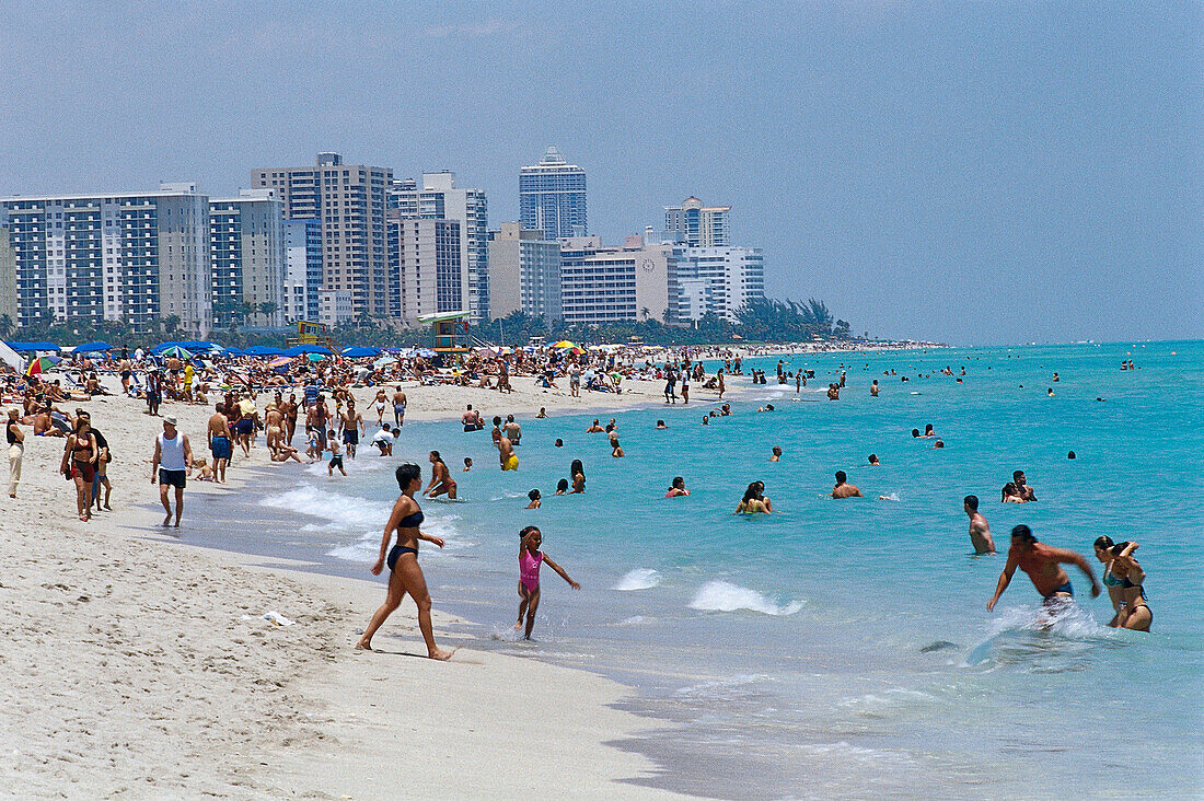 People strolling on the beach and bathing in the sea, South Beach, Miami Beach, Florida, USA, America
