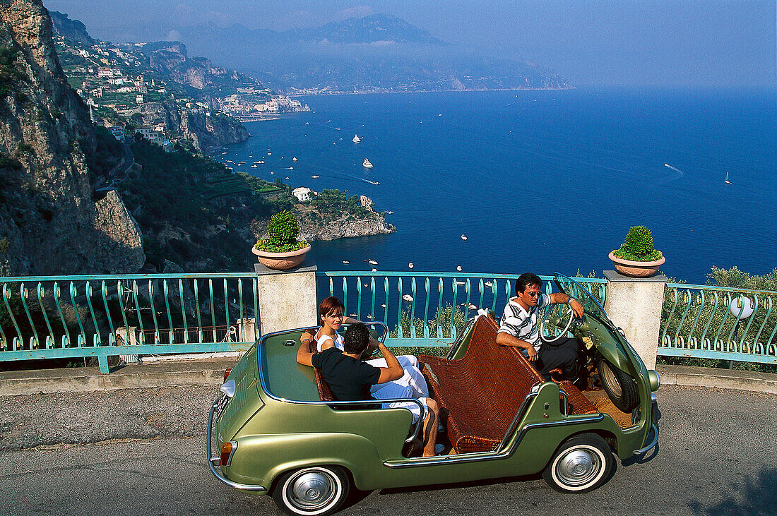 People in a vintage car at the coast in the sunlight, Amalficoast, Campania, Italy, Europe
