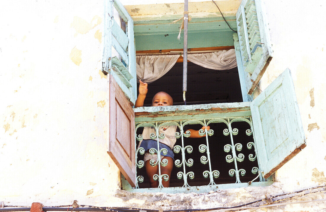 Waving boy, people on window