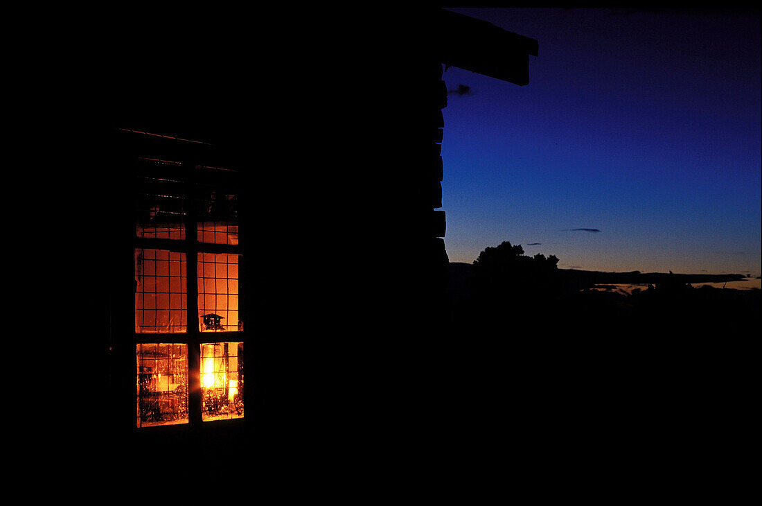 Illuminated window at night, landscape sunset