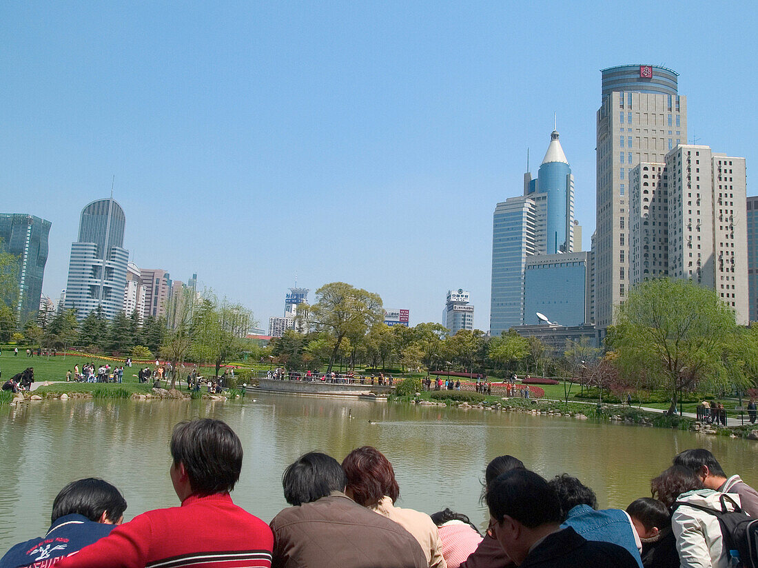 People in park with skyline, Shanghai, China
