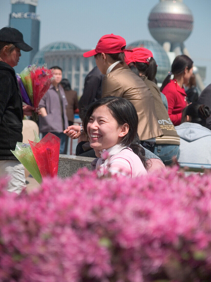 Laughing woman with flowers in Shaghai, Shanghai, China, Asia