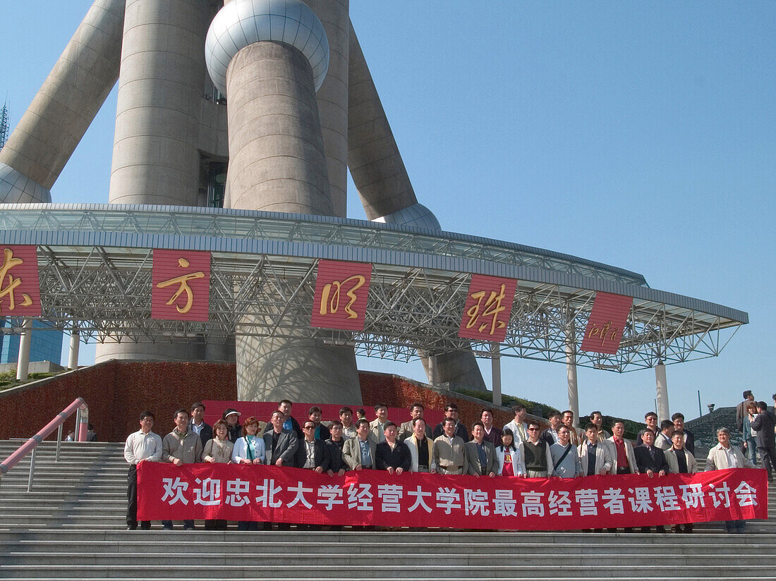 People with banner in front of pearltower, Shanghai, China