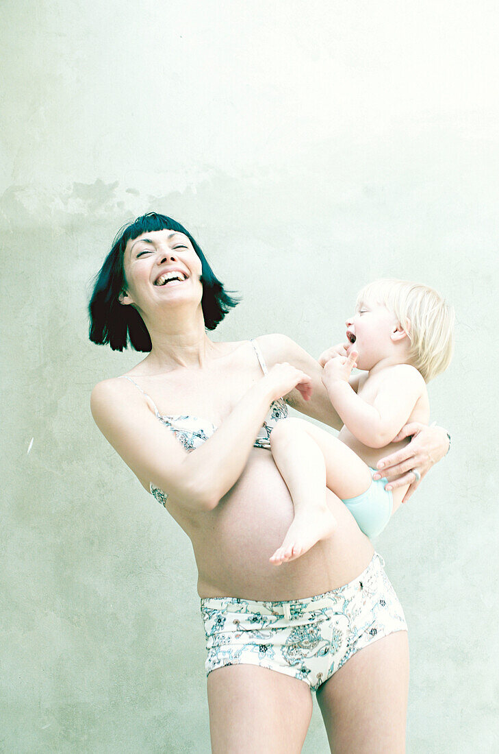 Pregnant woman playing with her daughter