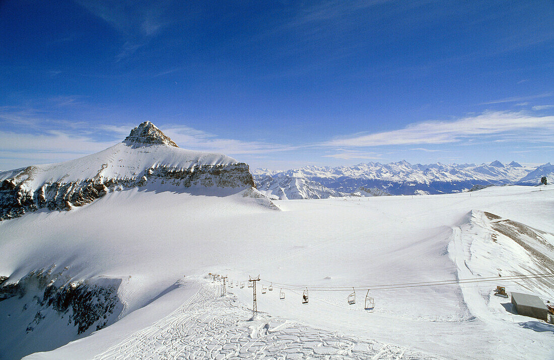 Ski lift at the sunlit Diablerets glacier, Oldenhorn, Gstaad, Switzerland